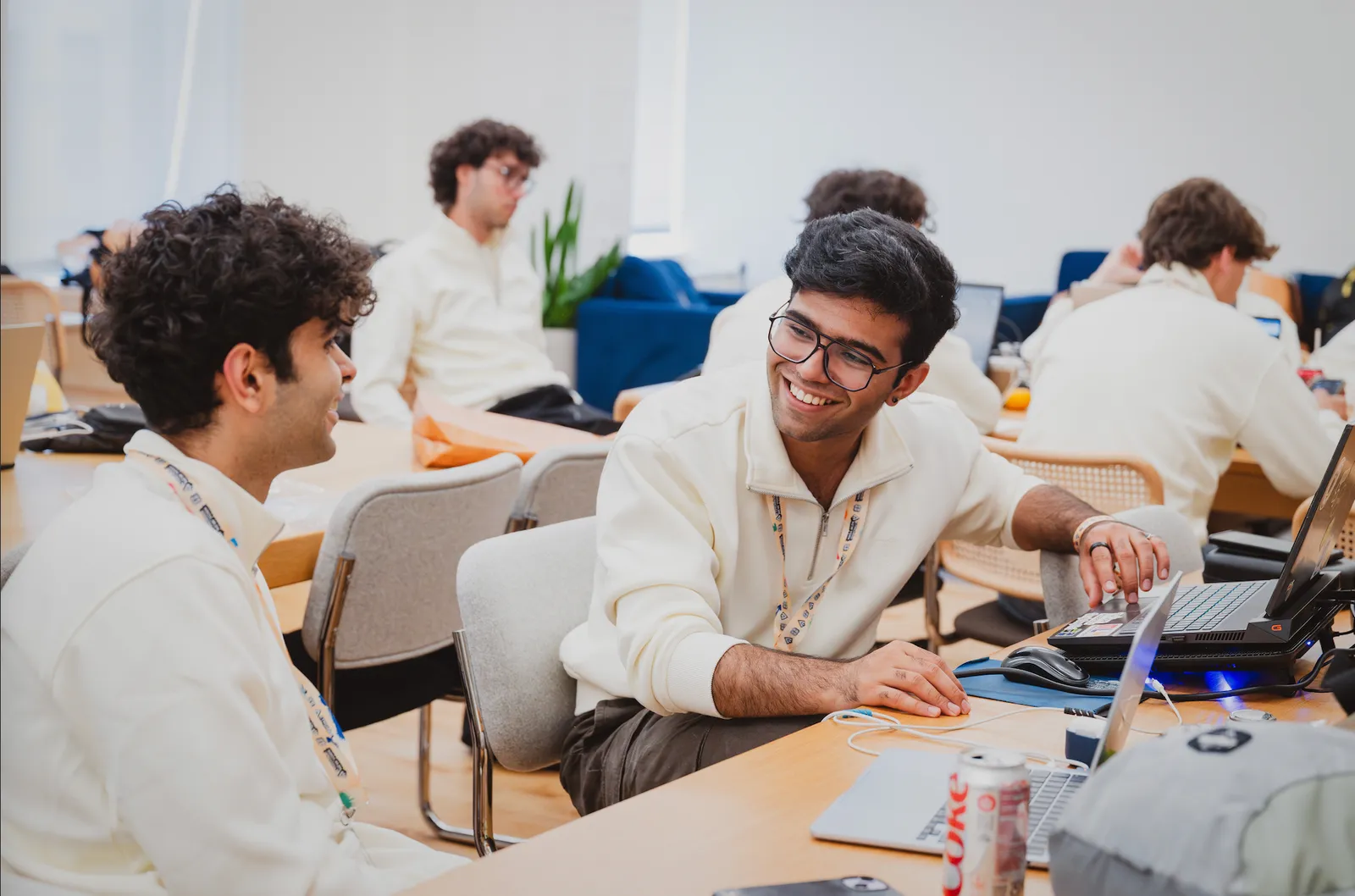 Jigar and a teammate working at a table during ETHGlobal New York.