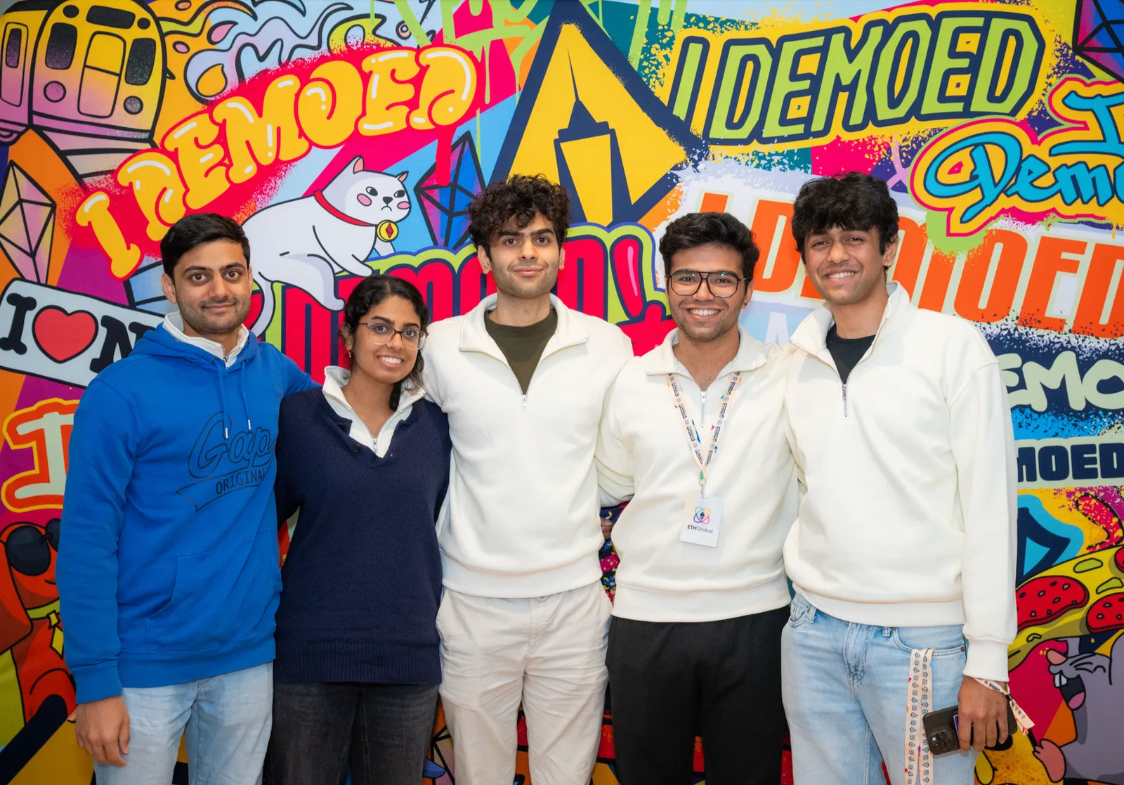 The CashMeIfYouCan team at ETHGlobal New York in front of an ETHGlobal mural.